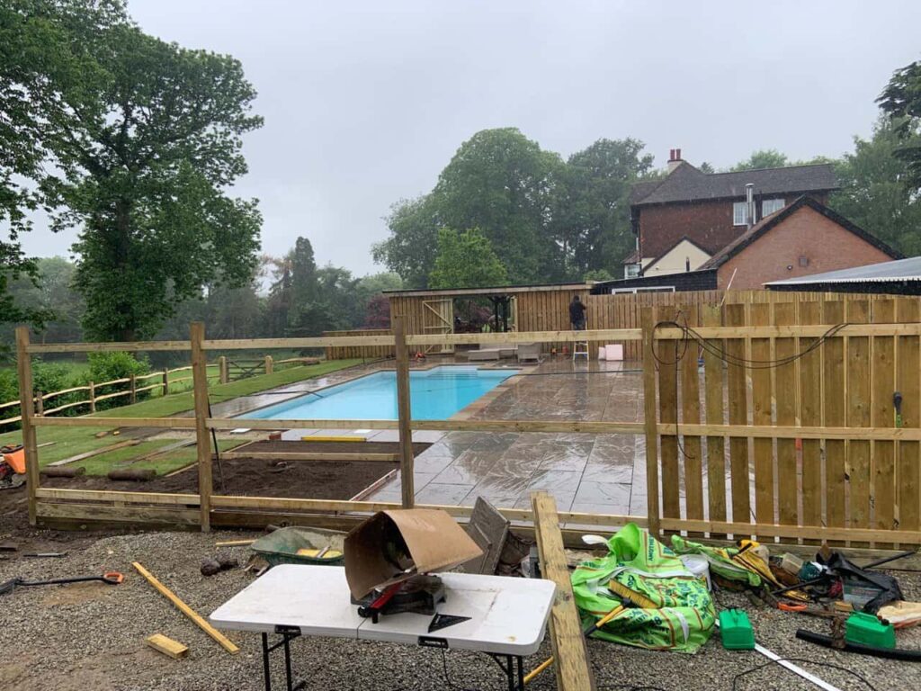 This is a photo of Bespoke custom fencing installed around a swimming pool by Fast Fix Fencing Cottenham
