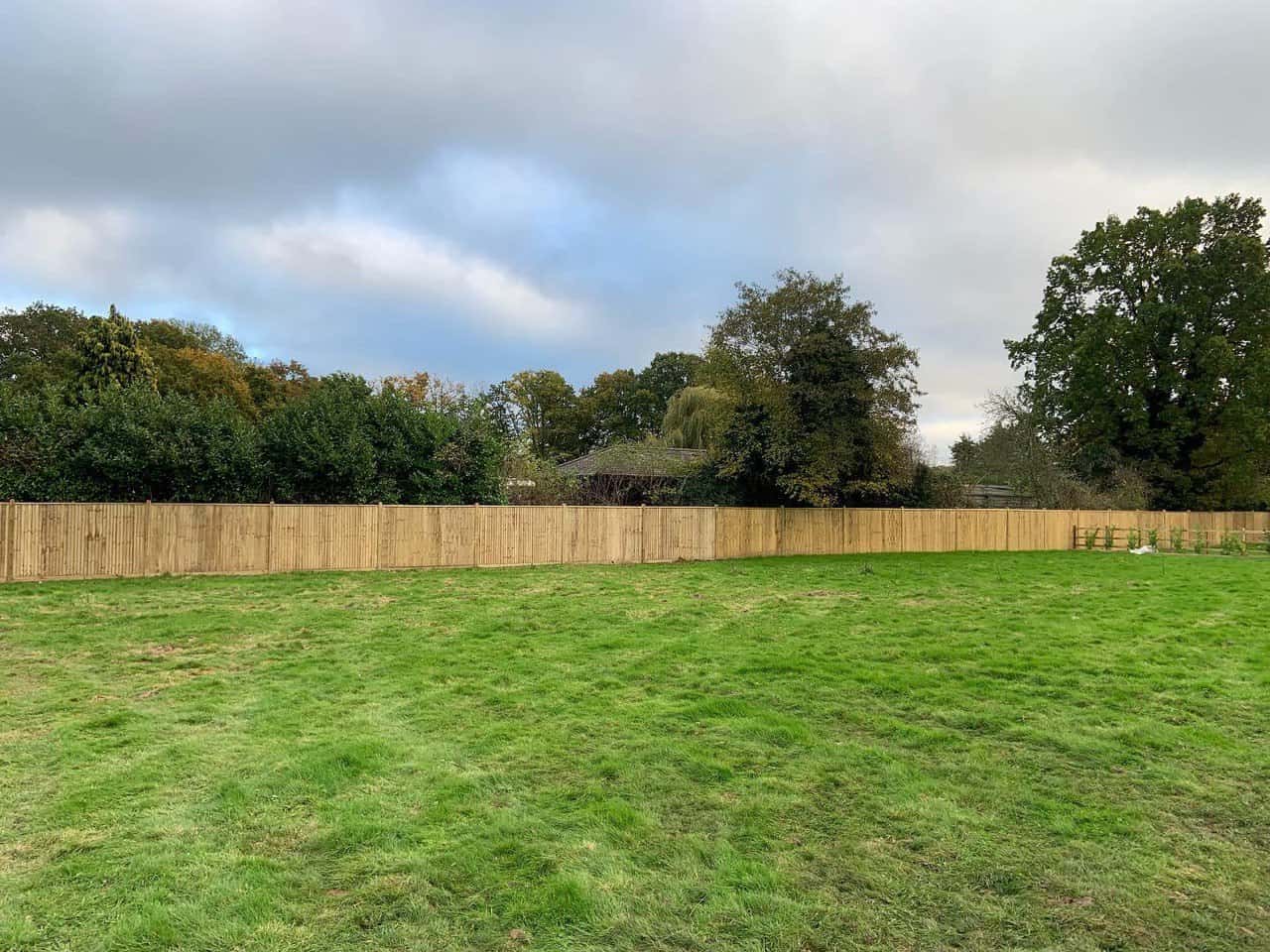 This is a photo of feather edge fencing installed around the edge of a field by Fast Fix Fencing Cottenham