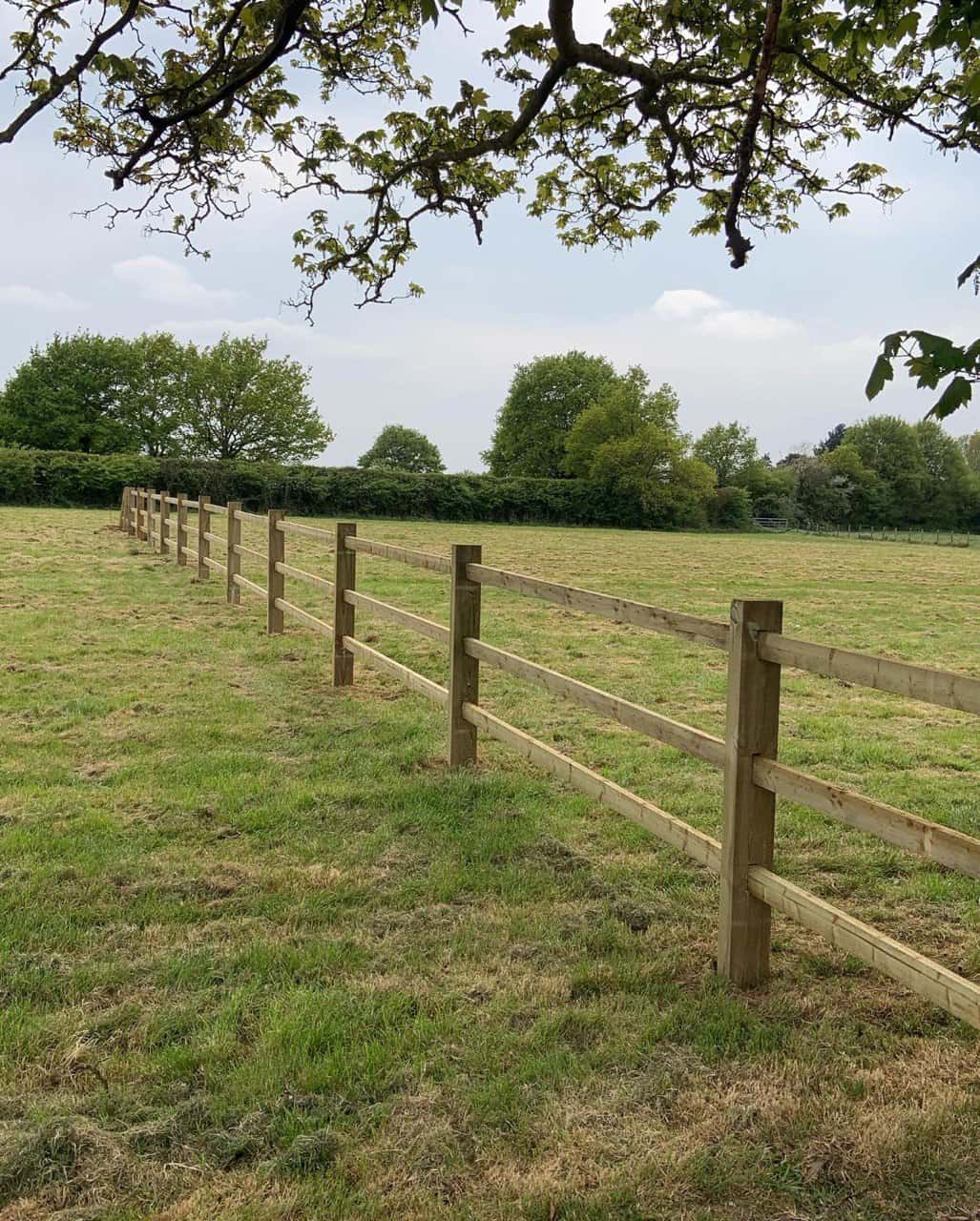 This is a photo of a post and rail fence installed in a field by Fast Fix Fencing Cottenham